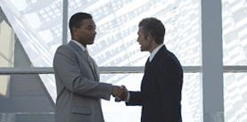 Two men shaking hands at airport